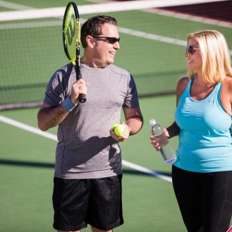 A man and woman converse with each other during a Pickleball tournament.