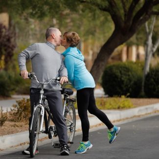 couple kissing while on tandem bike ride